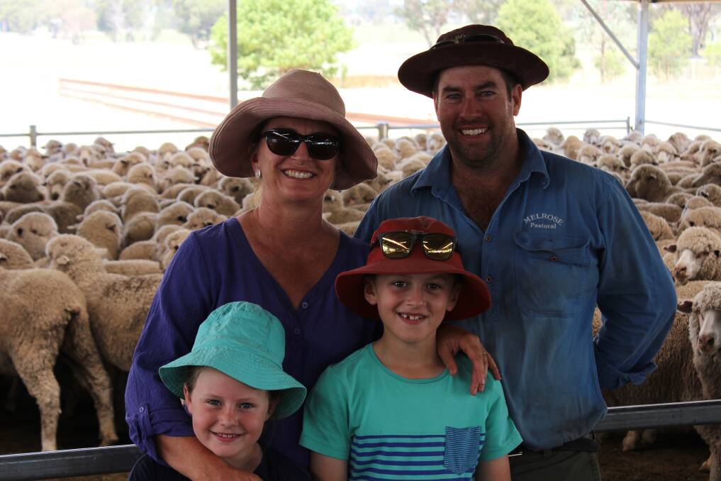 Sarah and Adam Wallace with children Lily and James undercover in their yards with Melrose bred maiden ewes penned for inspection at Wattamondara during the Mid Lachlan Merino flock ewe competition. 