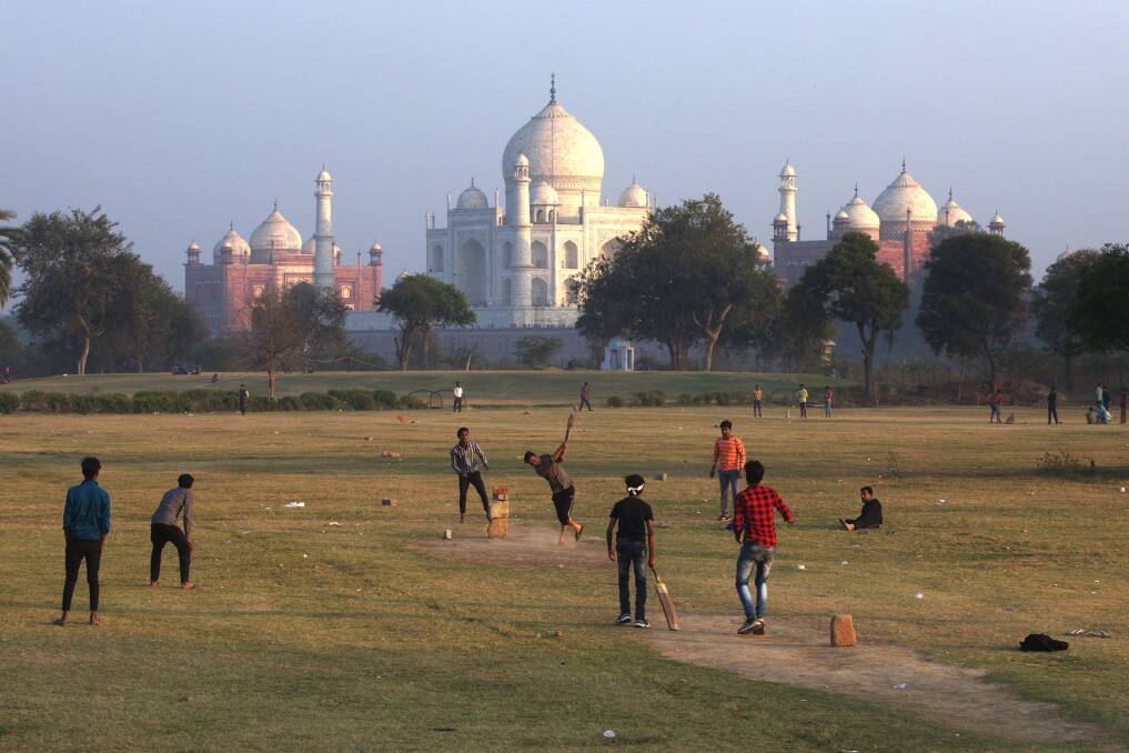 PICTURE THIS: A group of friends play cricket in the shadow of the Taj Mahal. Pictures: Steve Waugh