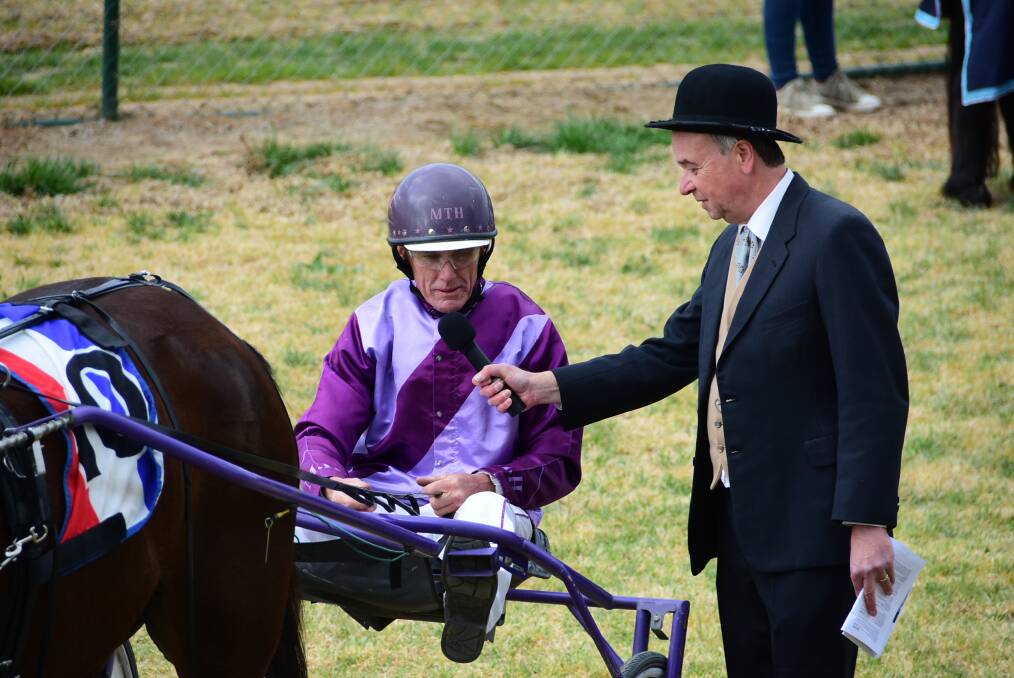 Bobby Street's trainer-driver Mark Hewitt speaks to Lawrance Ryan during the post race presentation after winning on Sunday afternoon. Photo: Ben Rodin