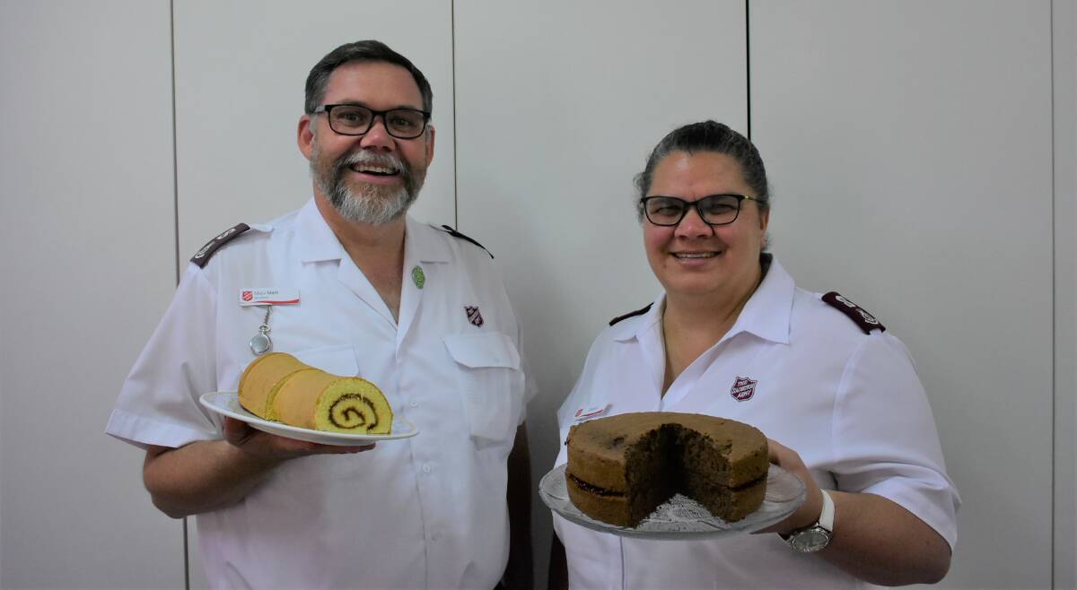 Mark and Cathryn Williamson with their prize-winning Royal Sydney Easter Show jam roll and cake. Photo: Ben Rodin