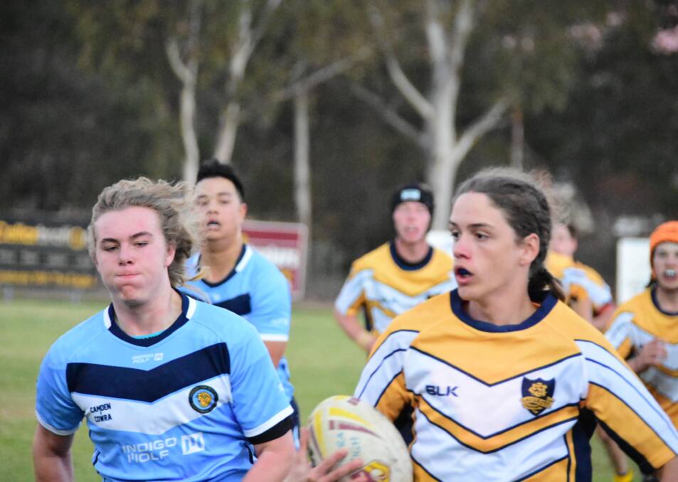 Around 200 people came down to Hartley Street to watch some intense school-level rugby league action. Photos: BEN RODIN