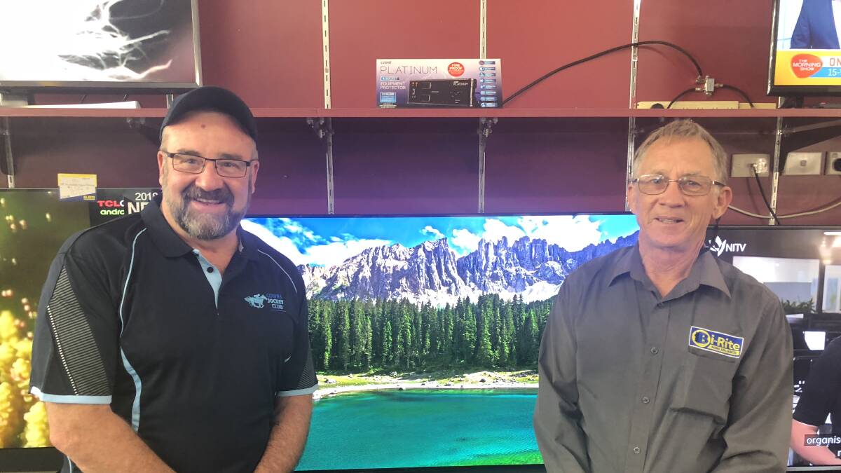 Cowra Jockey Club President Peter Ford and Martin's Bi-Rite Electrical owner Keith Martin are raffling off a TV with the winner to be drawn at the Cowra Cup. 