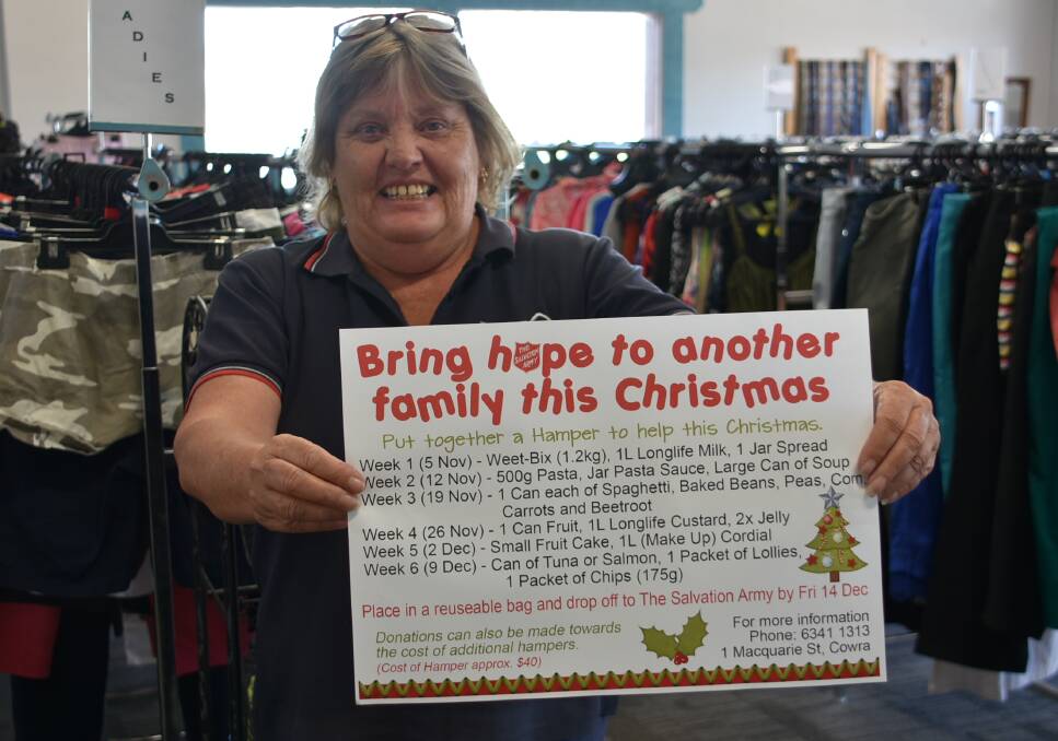 Salvation Army Store manager Jo Nobes with the list of items the Salvos are suggesting people donate for Christmas hampers.