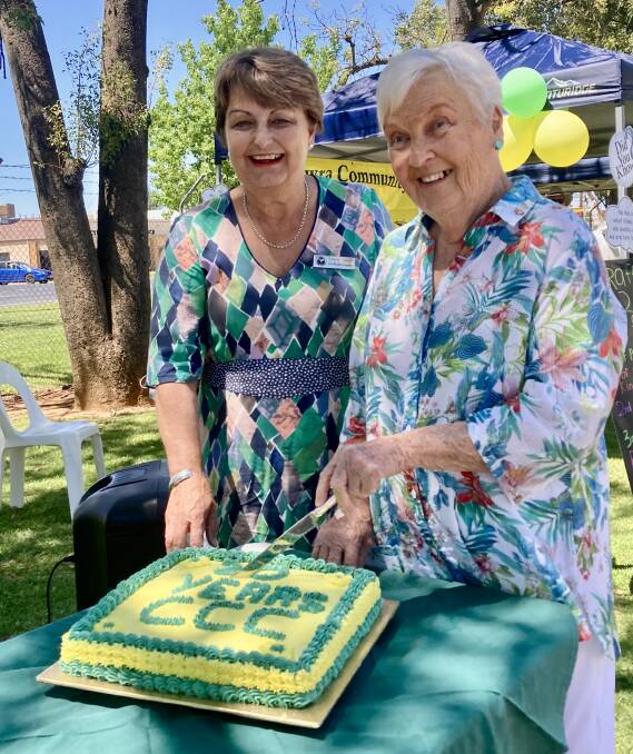 Cowra mayor Ruth Fagan and Kaye Chapman cut the Community Chest birthday cake at the Cowra Markets on Saturday.