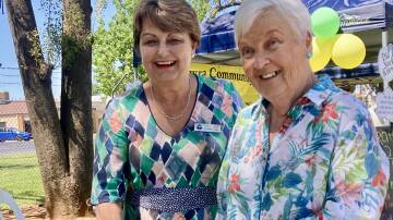 Cowra mayor Ruth Fagan and Kaye Chapman cut the Community Chest birthday cake at the Cowra Markets on Saturday.