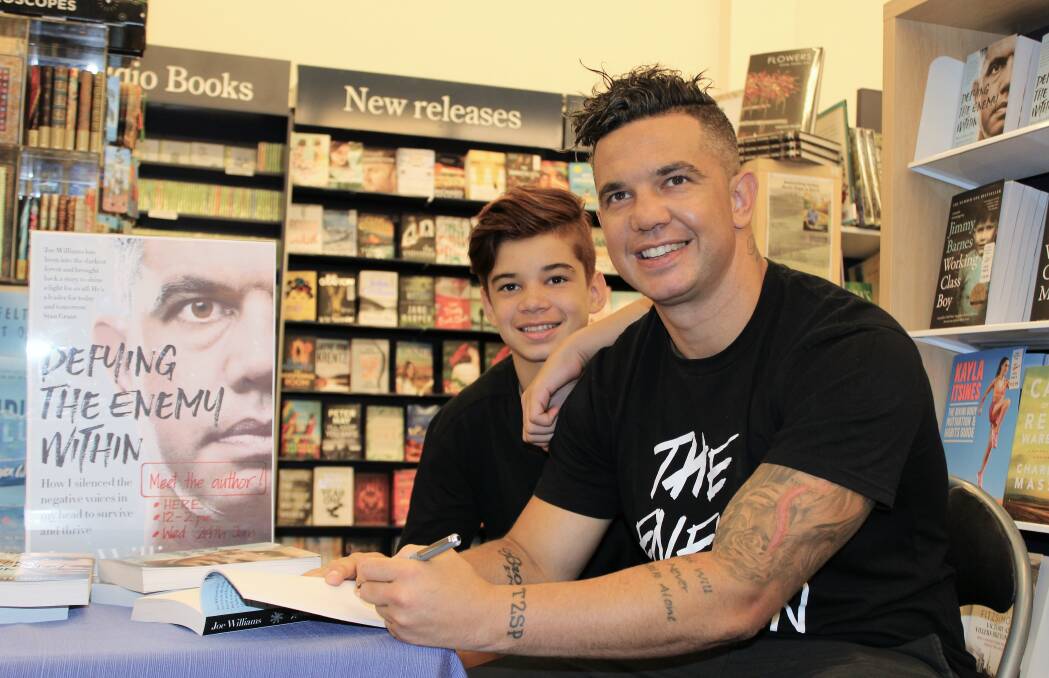 Off the shelf: Wagga man, sportsman and mental health advocate Joe Williams, with his son Brodi Williams, 13, launched his revealing autobiography in Wagga.