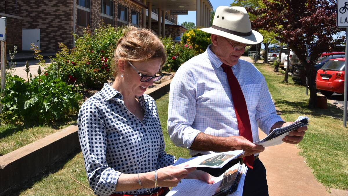 Member for Cootamundra Steph Cook and Cowra mayor Bill West look over some of the signed petitions to be tabled in State Parliament.