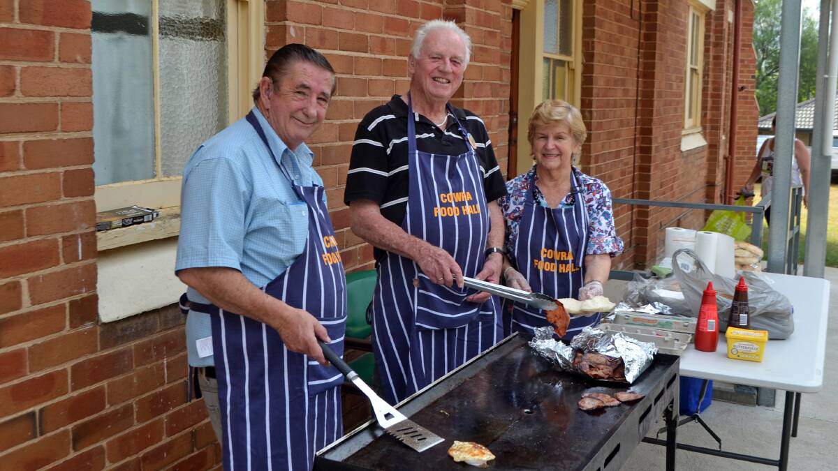 Cowra Food Hall volunteers cooking a barbecue to raise funds for the group which has again been named Cowra's Community Group of the Year.