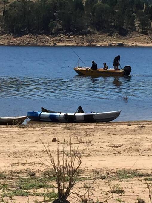NSW Police divers searching for the man's body at Wyangala Dam in February.