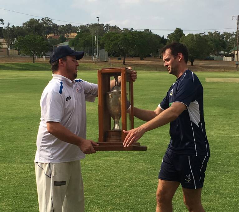 2018 Cowra cricket captain Nick Berry accepts the Grinsted Cup from Parkes captain Anthony Heraghty.