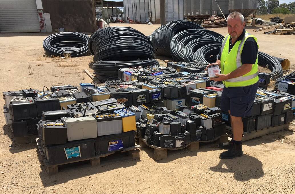 Lachlan Fertilisers Rural Storeman Greg Russell with some of the many batteries donated to Rotary in recent months.
