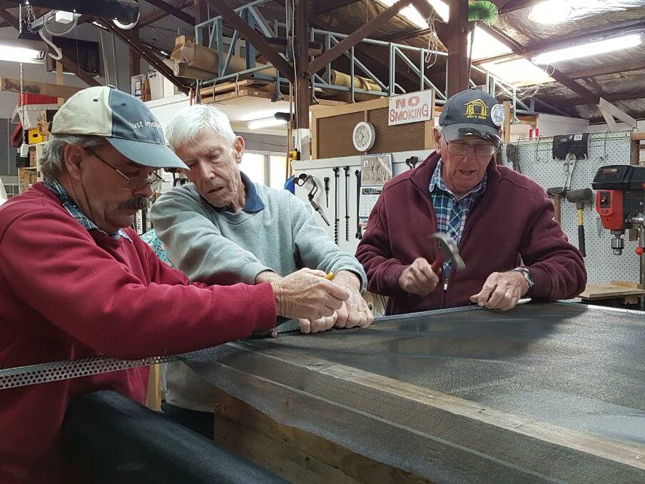  Rob Solling, Chris Bryant and Peter Boler working on a dung beetle nursery at the Cowra Men's Shed.