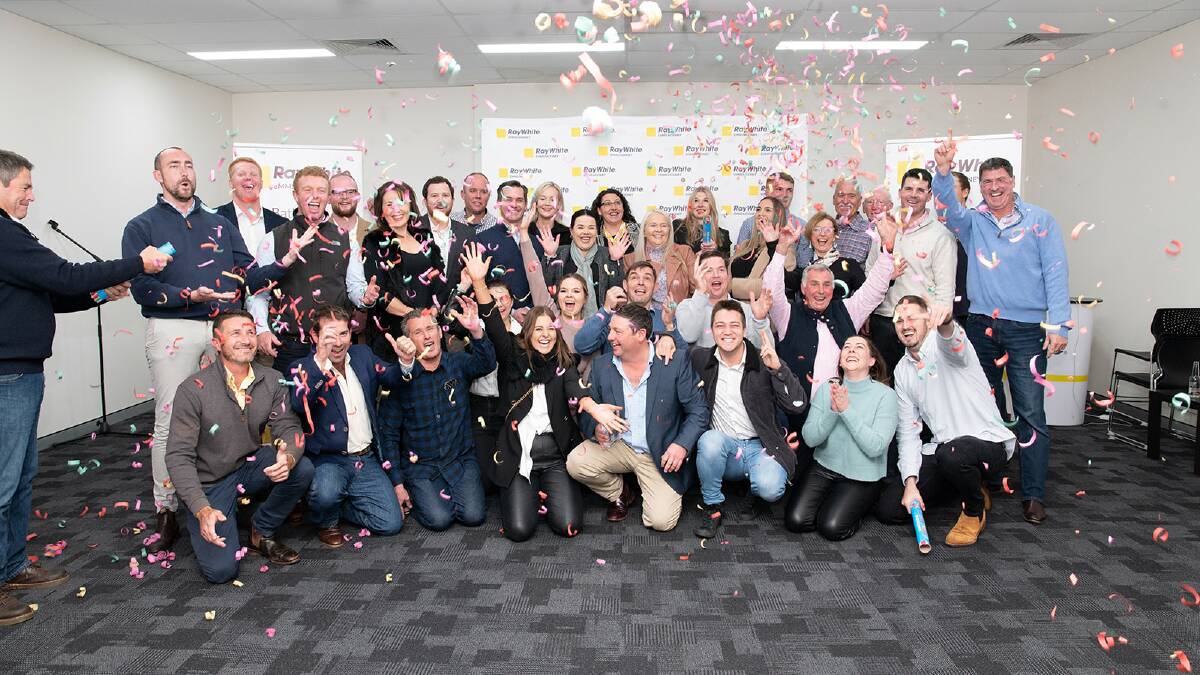 The Ray White Emms Mooney staff celebrating their recent achievements.