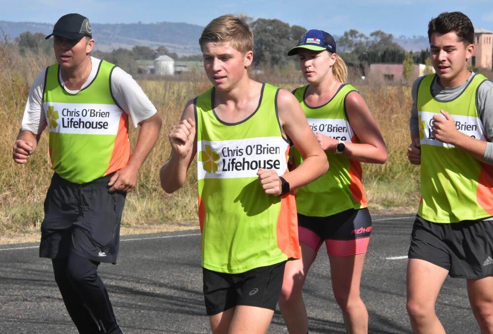 Riley Whatman (right) with his father Shane, brother Angus and Kinisha Roweth on the approach into Cowra on Sunday after running from Gooloogong to raise funds for the Chris O'Brien Lifehouse.