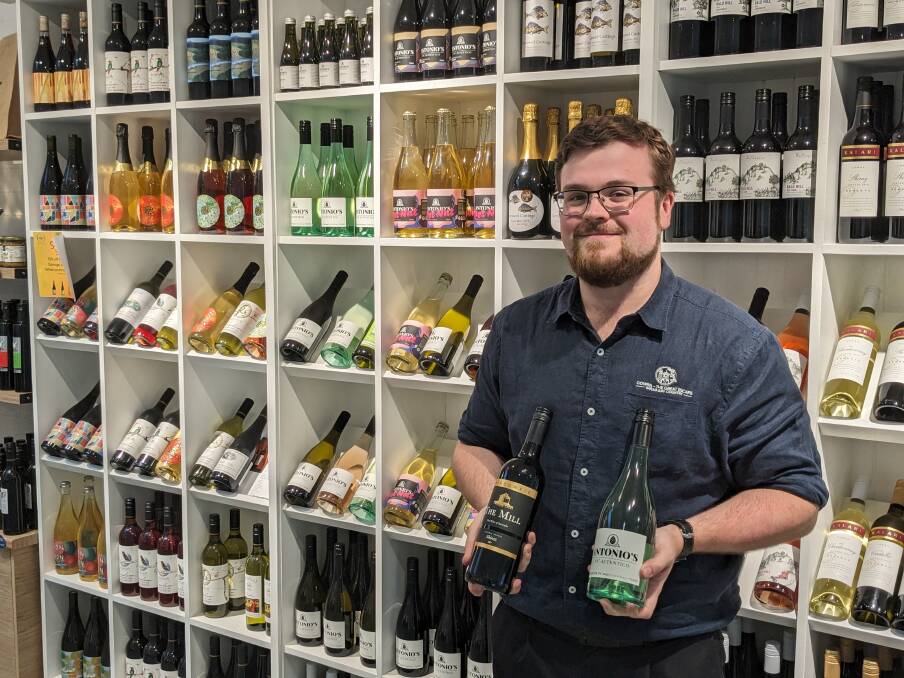 Kurt Overzet with the local wine offerings at the Cowra Visitor Centre.