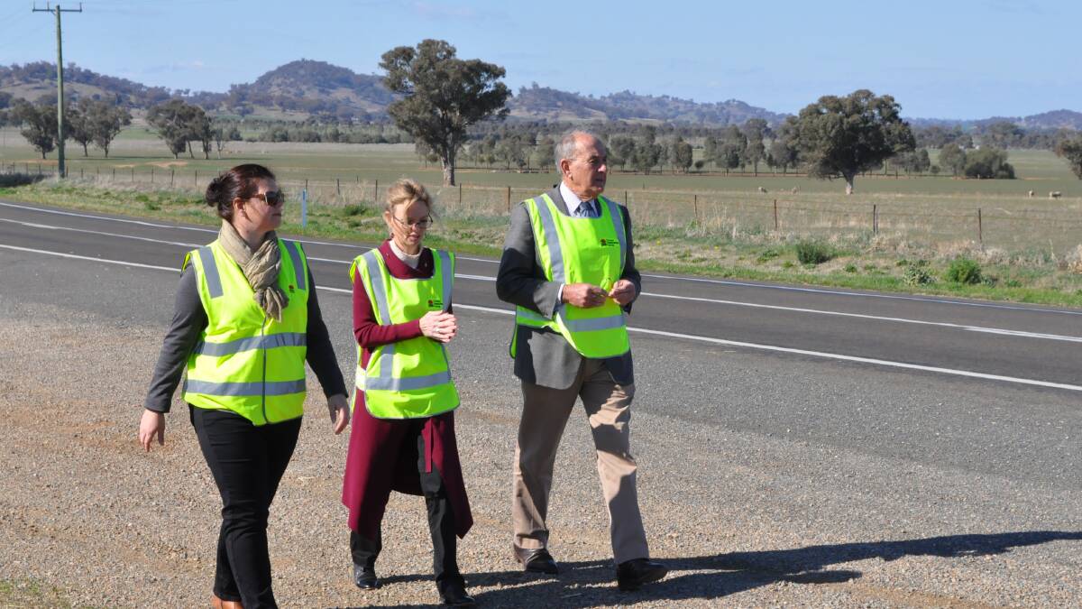 Jodie McIntyre, Acting Network and Safety manager with the RMS, Member for Cootamundra Steph Cooke and Cowra mayor Bill West inspect the site of the roadworks on Monday.