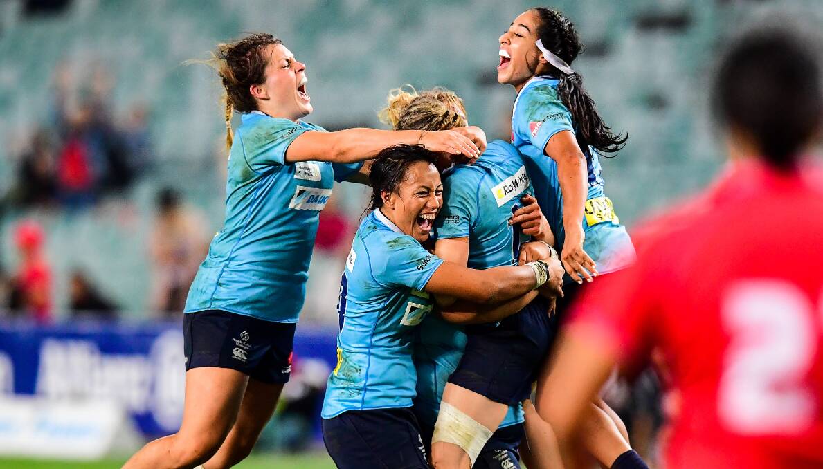 ABSOLUTE SCENES: The NSW Waratahs mob skipper Ash Hewson after she landed a title-winning penalty goal in the 92nd minute of Friday's final. Photo: STUART WALMSLEY/ARU