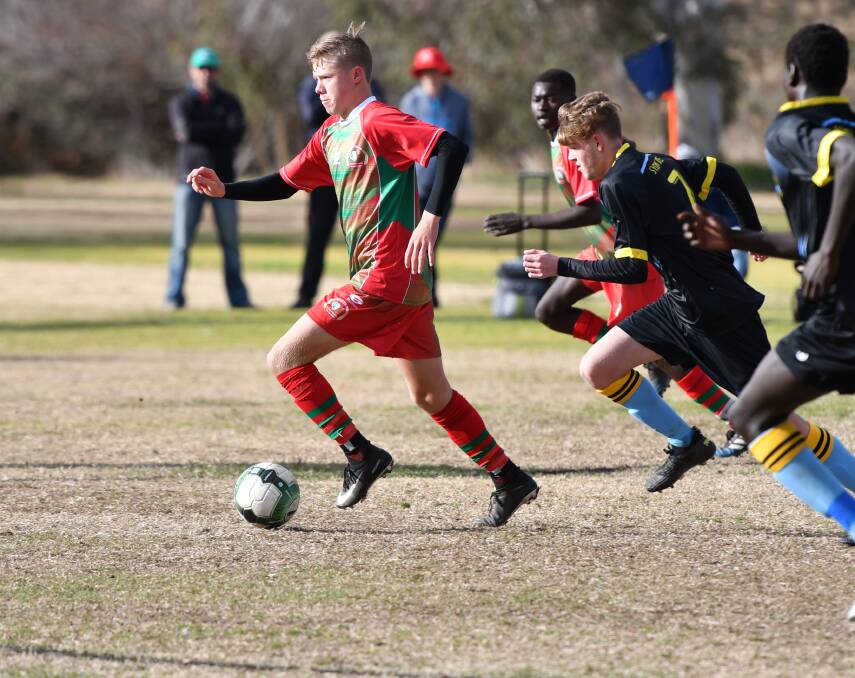 Orange High School's Mitch Cooper and Cowra High's Dinous Bahini find open space through the midfield. Photo: ALEXANDER GRANT
