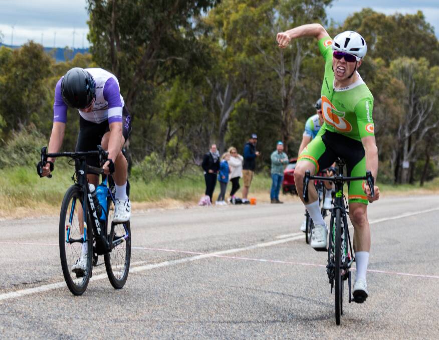 YOU BEAUTY: Will Hodges throws his arm up in celebration after winning the NSW Men's Elite Road Road title. Photo: RYAN MIU
