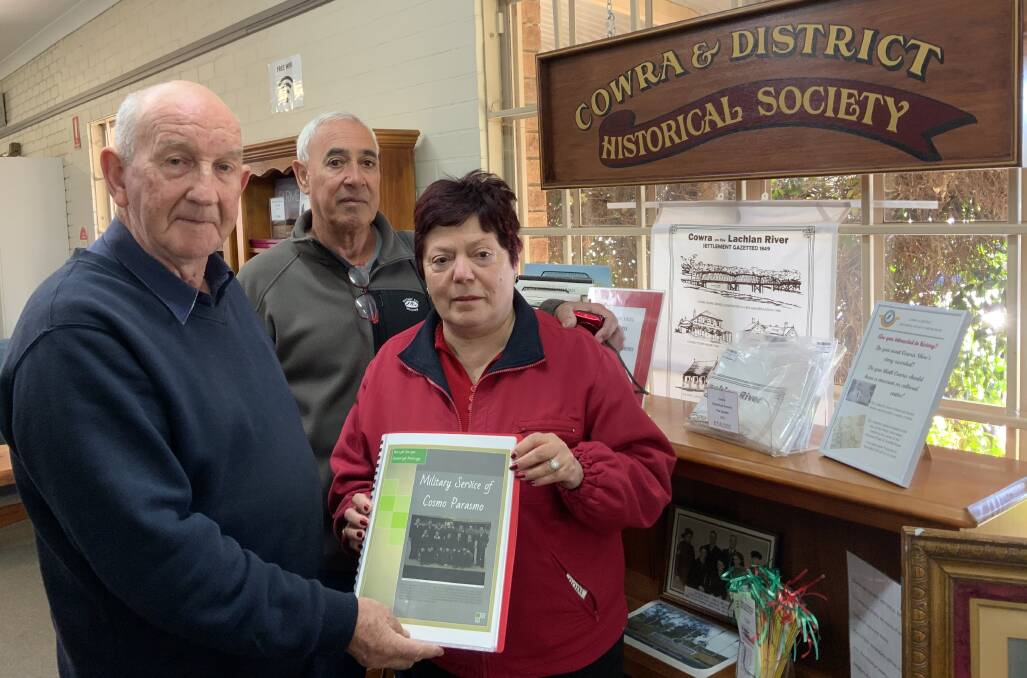 Benedetta Parasmo and her partner Leo Garcia presenting her father's POW story to Historical Society President Ray Walsh.