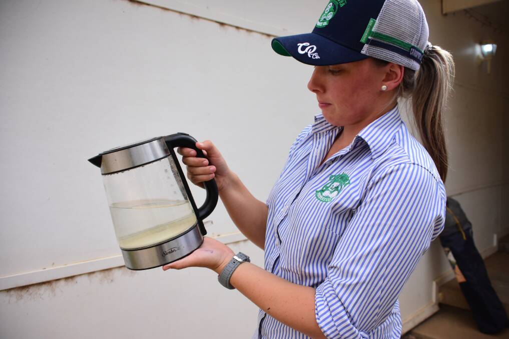 Becky Thornberry shows the murky water inside her kettle. Despite continuous cleaning, she says the water leaves a build up of residue on kettles and taps. 