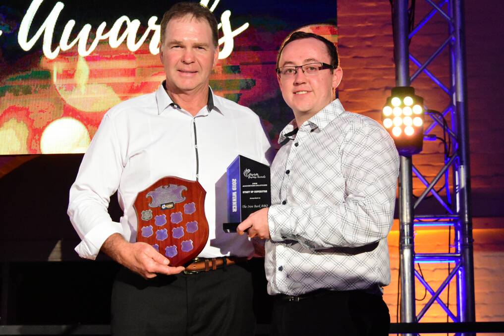 David Tidswell (accepting the award on behalf of The Iron Bark BBQ) with David Symons from SWM Accounting Solutions. 