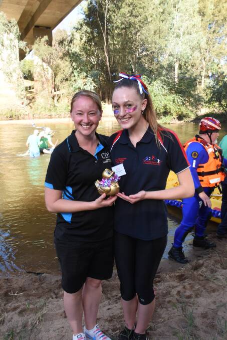 Larrisa Pullen and Maisie Thompson show off a duck at last year's Festival Rotary Duck Race. Photo: Lizz Dobson
