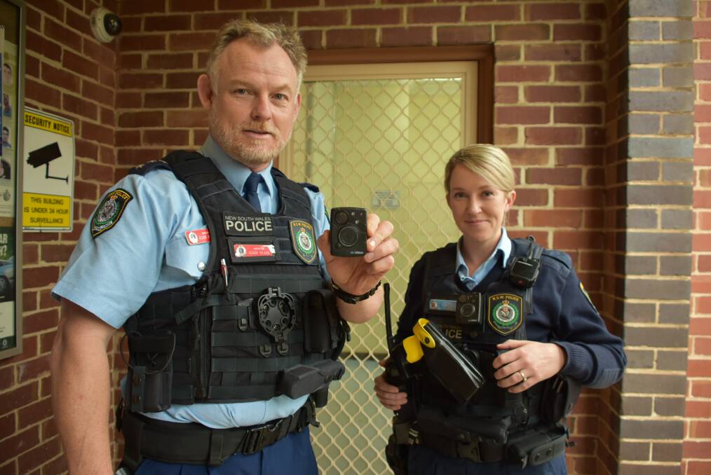 Cowra Police Inspector Adam Beard and Probationary Constable Bec McCorkindale show off the Body Worn Video (BWV) cameras Cowra Police will now be wearing. 