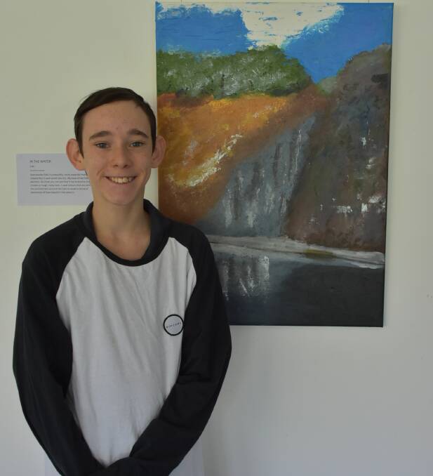 Artist Elijah Austin in front of just one of his paintings at the Cowra Japanese Garden. His "Sights of Cowra" exhibition runs until the end of July. 