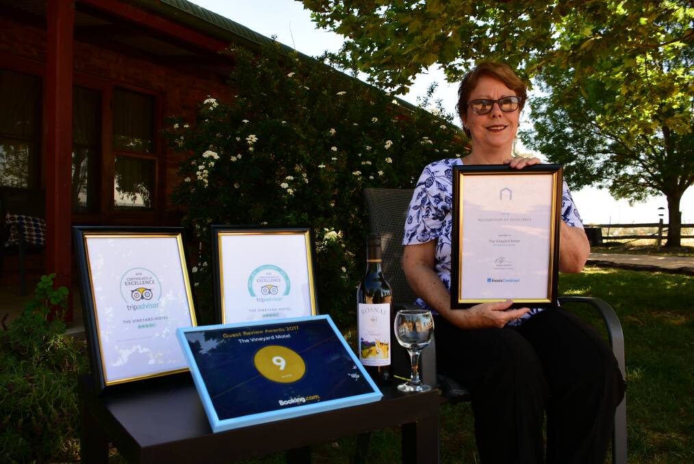 Wendy-Jane Saywaker with her awards from TripAdvisor, Hotels Combined and Booking.com