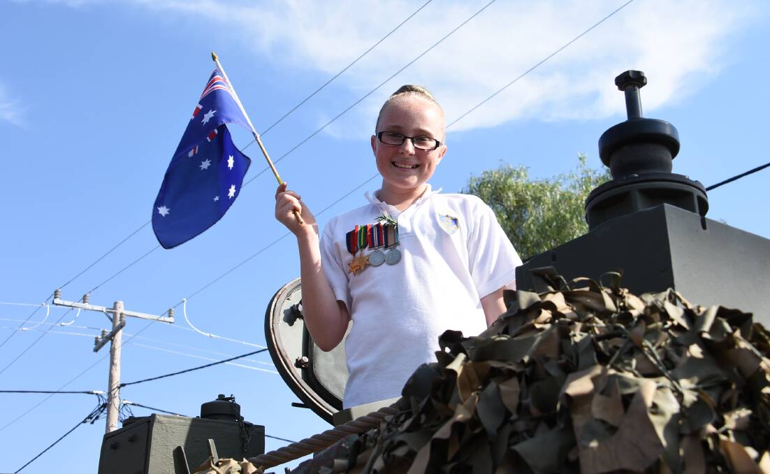 Hayley Annetts proudly displaying her great grandfather's medals at last year's Anzac Day march in Woodstock. 