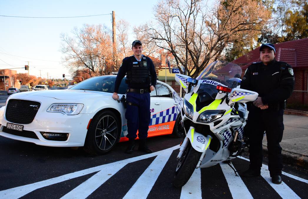 Constable Patrick Fisher and Sergeant Mick Chooi with the new Chrysler Highway Patrol car and motorbike. 