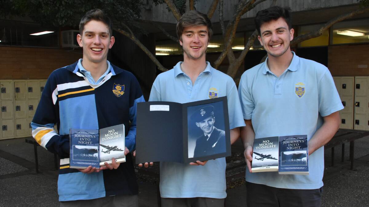 Cowra High School Vice Captain Lochie Wilson, Captain Samuel Long and Vice Captain Noah Ryan with copies of the books. 