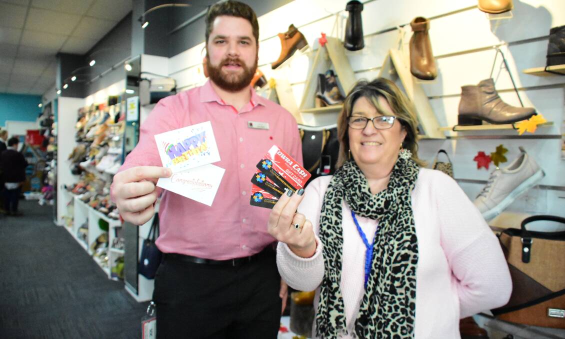 Cowra Business Chamber President Jordan Core and Peggy Beer with Cowra Cash Cards. 