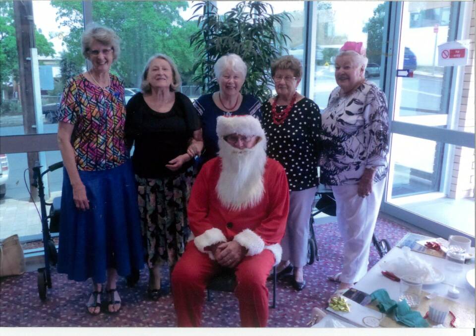 Jenny Anderson, Margaret Hall, Mary Bastiaansen, Pam Mackey, Ann Reeves and Santa at the 2019 Christmas meeting. File photo. 