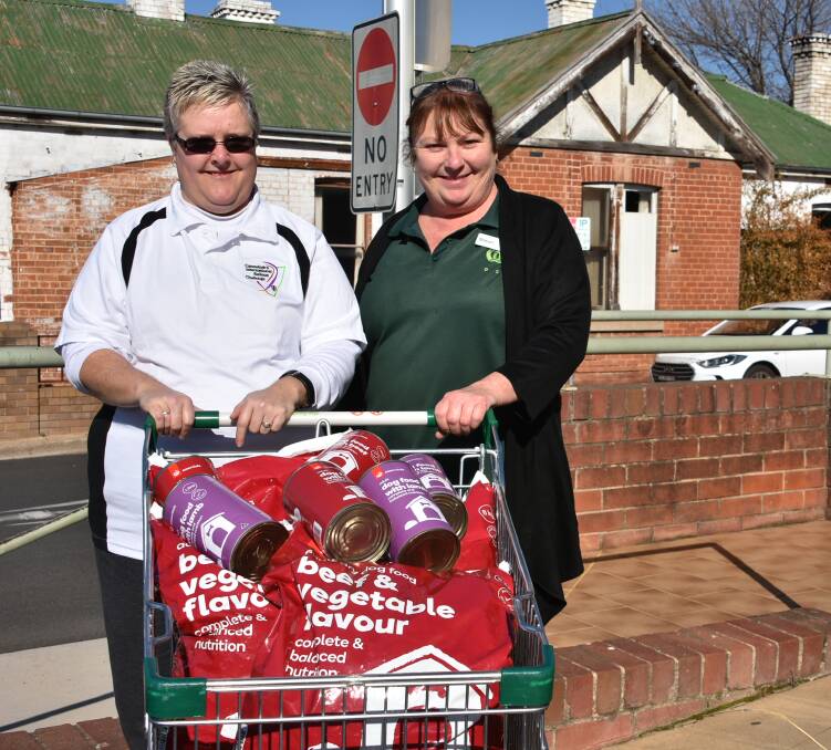The Cowra Guardian's Kerry Quin with Sharon Beath from Woolworths. An anonymous customer donated a trolley of dog food on Friday morning. 
