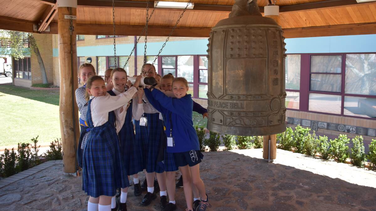 Cowra Public School students ring the World Peace Bell at last year's World Peace Day celebrations. 