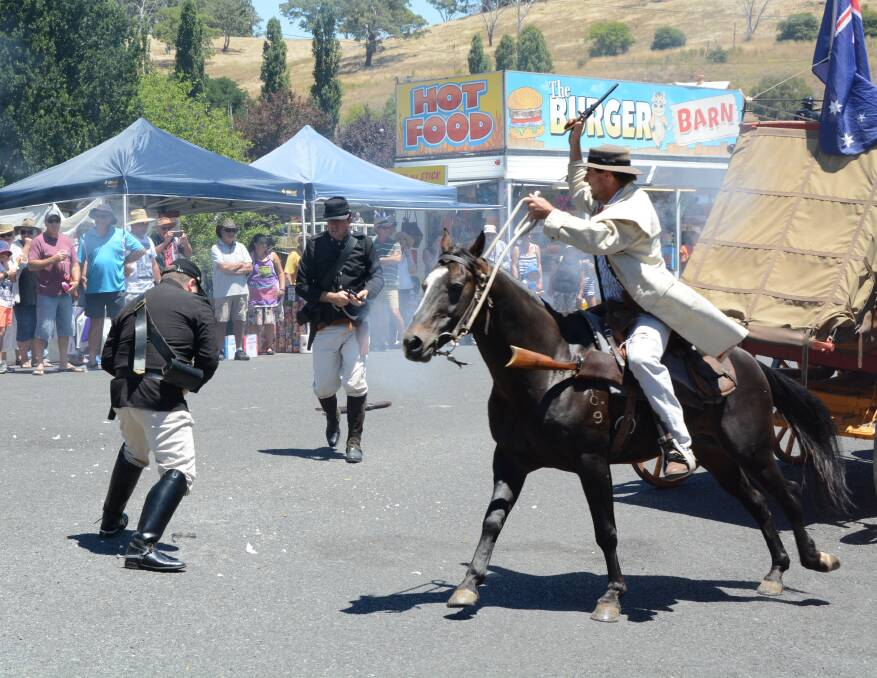 Stick em up: Members of the Gold Trails Re-enactment Group performing at the Carcoar Fair. Photo: Mark Logan.