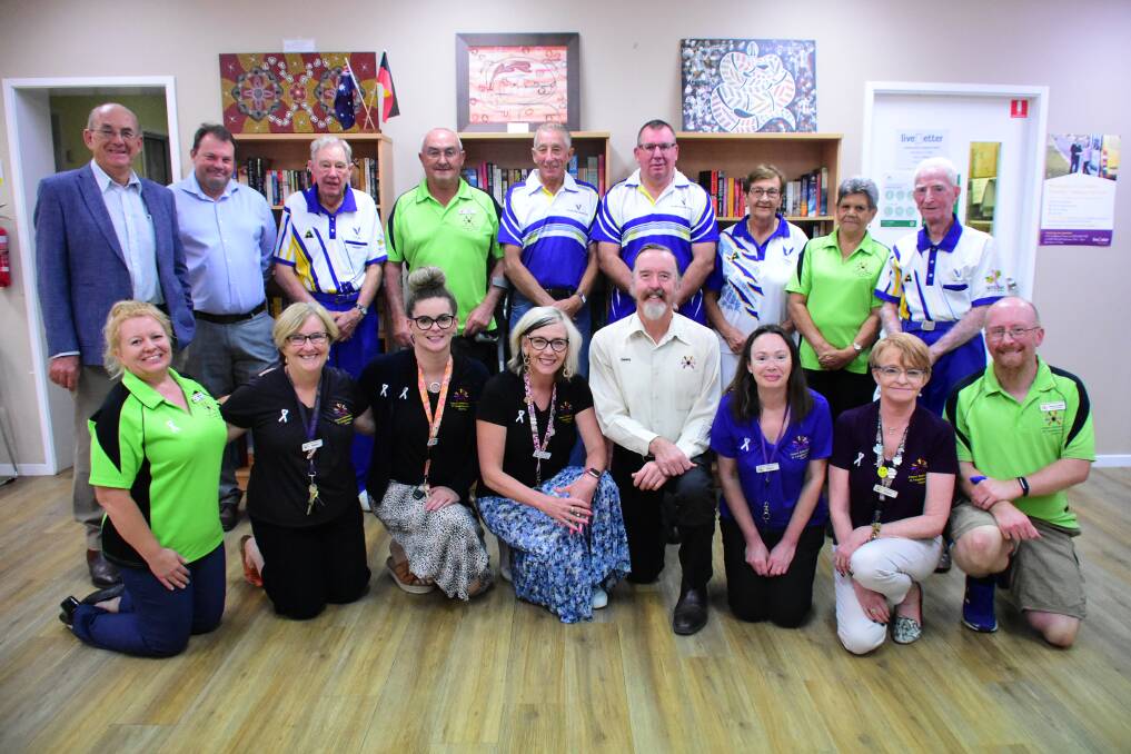 Staff from Cowra Information and Neighbourhood Centre with the Cowra Bowling Club's Board of Directors and Cowra Mayor, Councillor Bill West (back row, far left) 