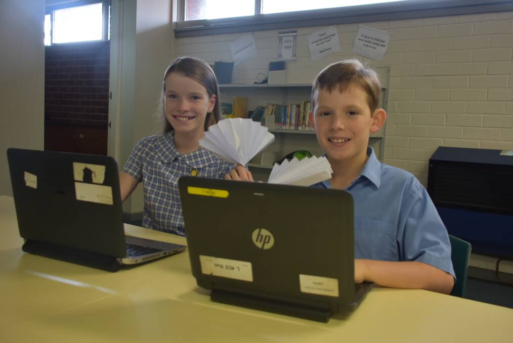 No need for fans anymore students! Niamh Webster and Samson Miller from Cowra Public School are keen to receive air conditioners at school. 