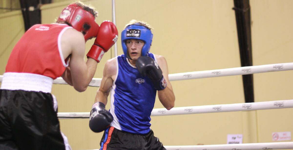 Cowra amateur boxer Josh Lawler keeps a sharp eye on his opponent on his way to securing the NSW Country Super Lightweight title. Photo by Tommy Photography.