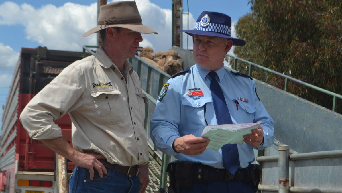 Chris Gailey and Cowra Police Inspector Adam Beard check compliance at the Cowra saleyards. Police are pushing rural crime patrols across the region.