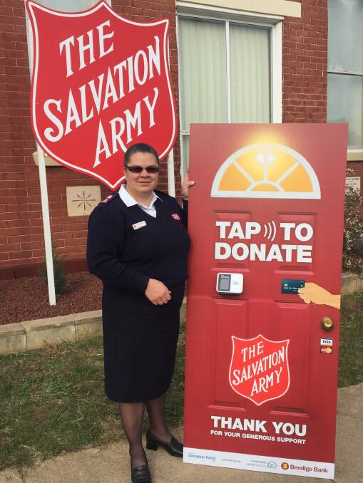 Major Cathryn Williamson of The Salvation Army Cowra shows off the new donation tap point she will use to help raise money for the Red Shield Appeal.