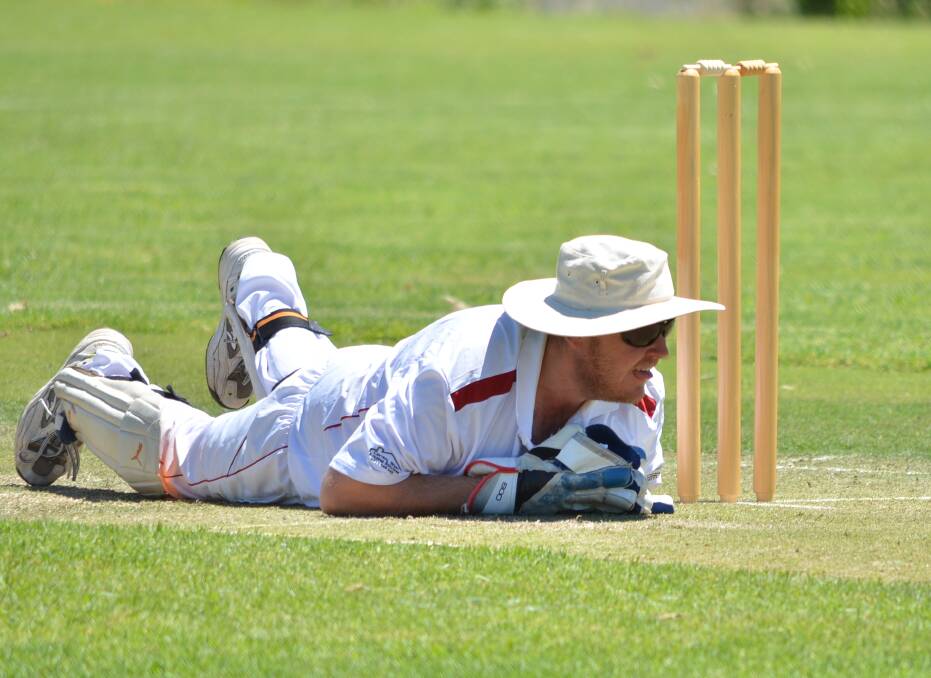 Craig Carpenter dives during a run out chance in Saturday's match at Twigg Oval. Canowindra won by two wickets.