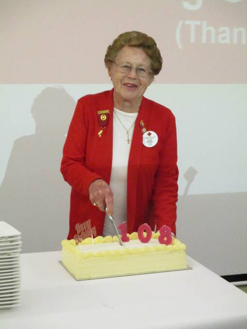 Elsie cutting the cake celebrating the Red Cross' 108th birthday on Wednesday. Image supplied.