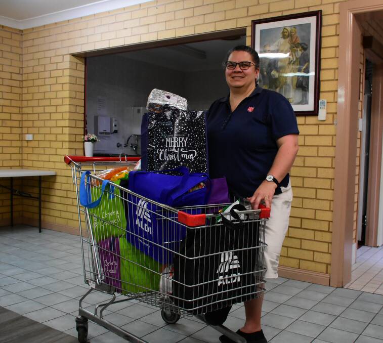 Major Cathryn Williamson with a trolley full of hampers ready to be distributed.