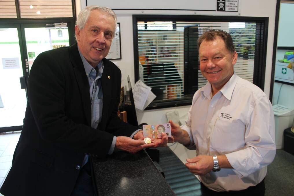 Chair of the Anniversary Committee Graham Apthorpe paying the special $7.50 entry fee to Manager of the Japanese Garden and Cultural Centre Shane Budge.