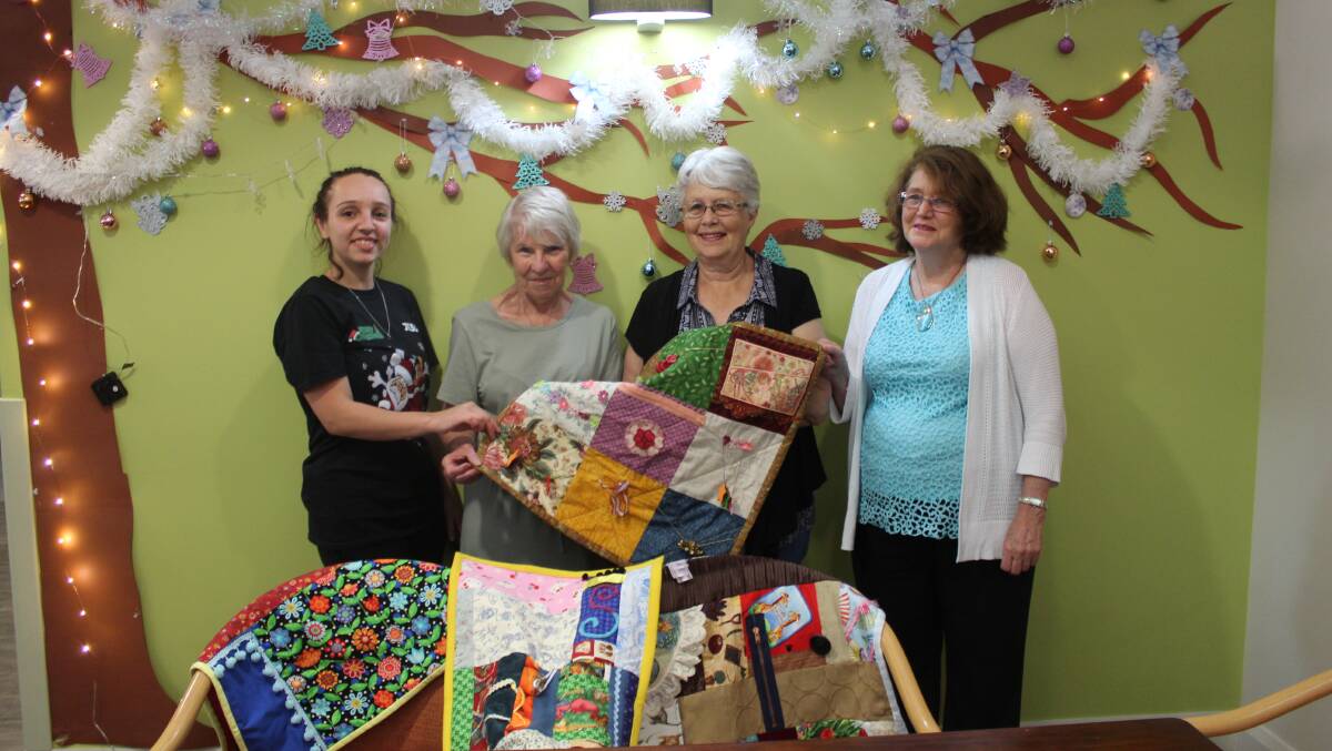 Jess Taylor presented with fiddle blankets made by Diane Walsh, Ruth Brooks, Sheryl Worth and the Cowra quilters group.