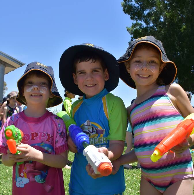 Mila Anthony, Antonio Adattini and Emily Forbes cool off at Cowra Public School's water fun day. The trio all made sure they were sun safe before heading out to play. 