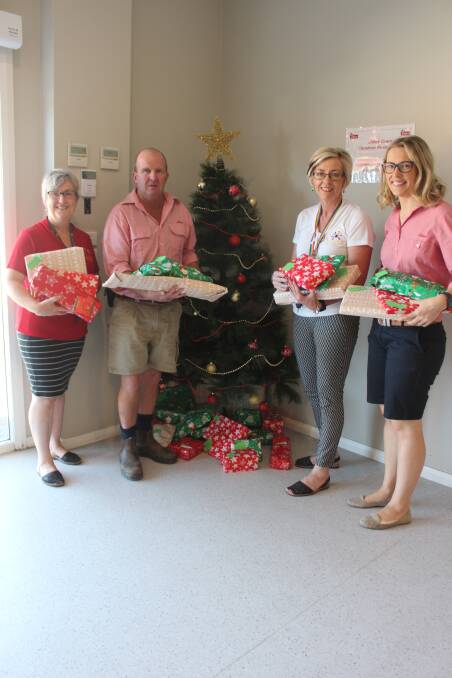 Marion Speechley, Patrick Finn, Fran Stead and Nicole Spolding with the presents donated by Elders.